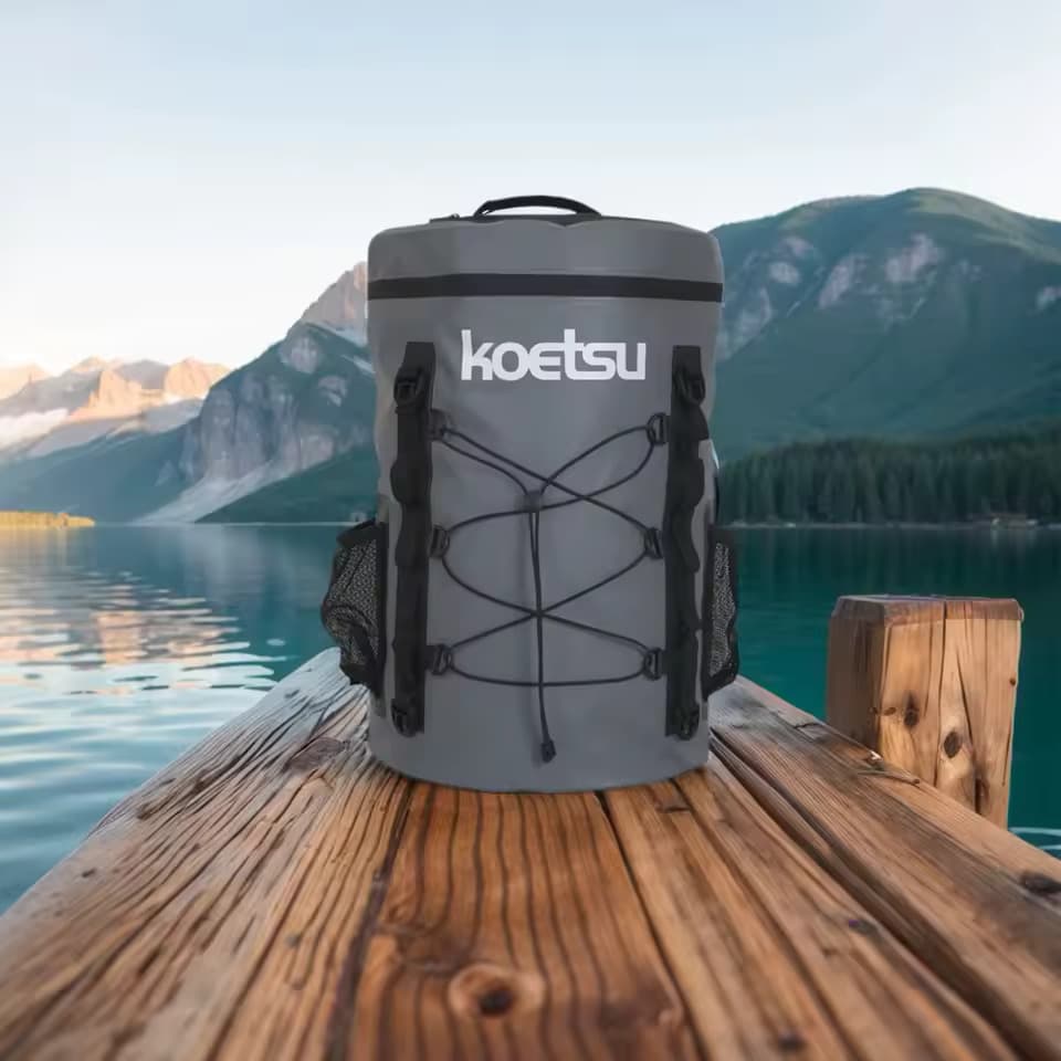 Koetsu 40L Zipper-Top Dry Bag on mountain lake dock with snow-capped peaks